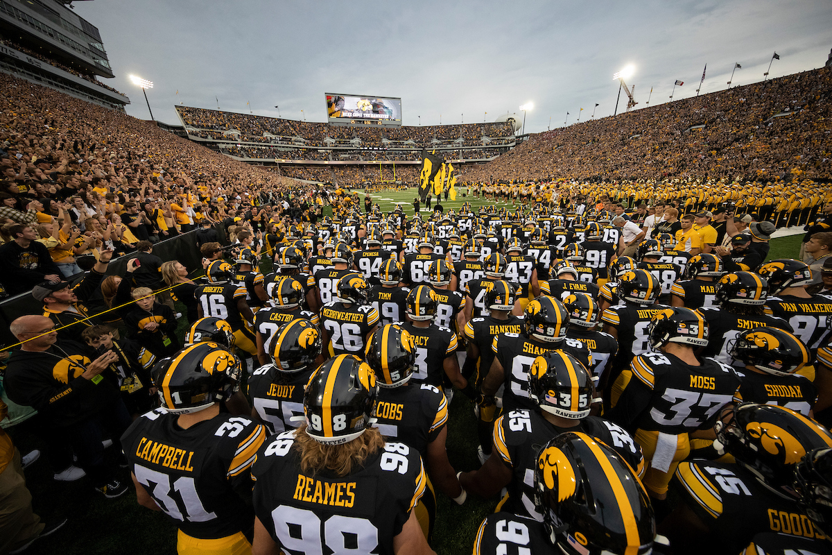 Iowa Football Team in a huddle